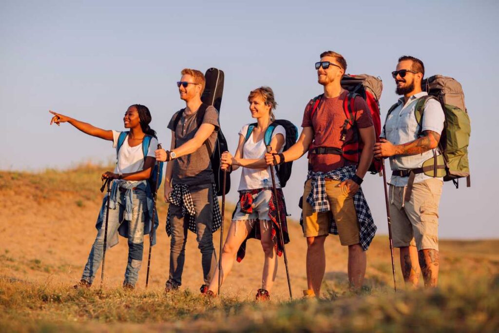 five friend in the desert pointing their path