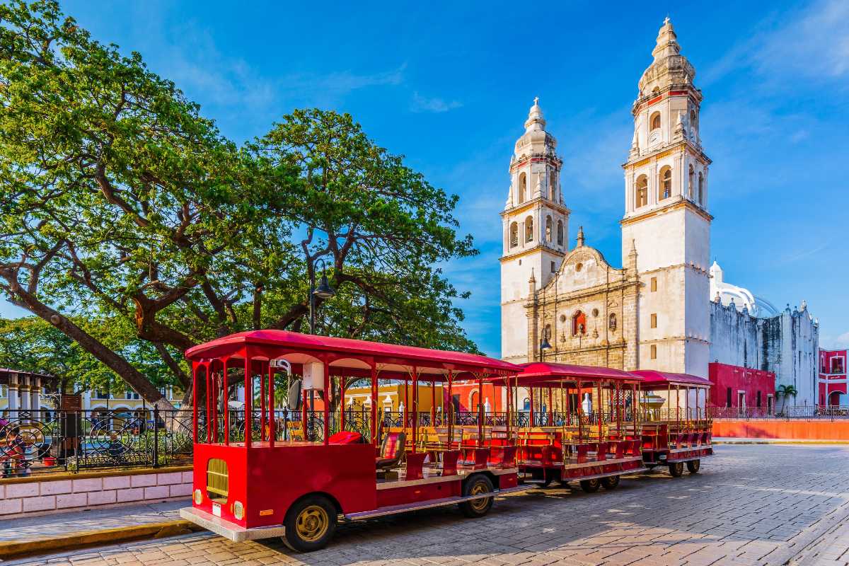 a red tours bus in front of big church